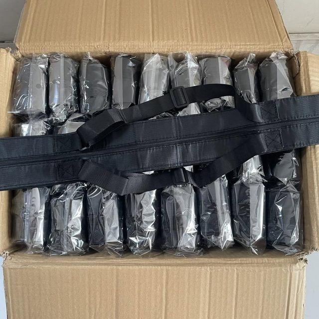 Carton filled with individually polybagged black corporate bags, ready for dispatch.