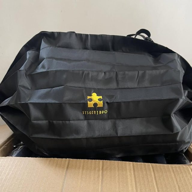 Finished corporate bag with a gold embroidered logo, packed in a carton.