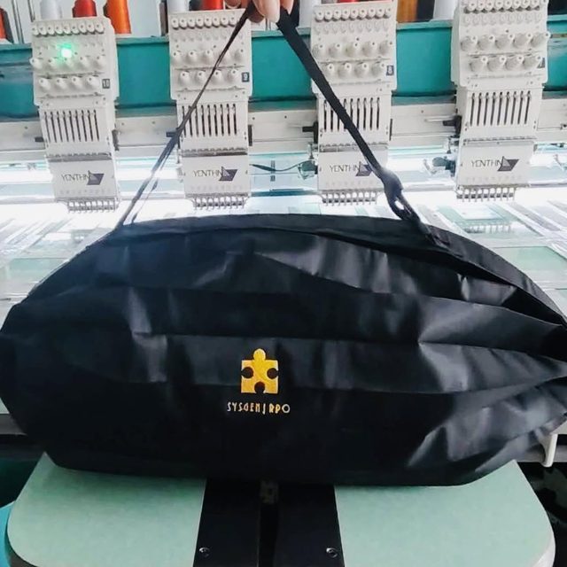 Corporate bag mounted on a multi-head embroidery machine while the logo is stitched.